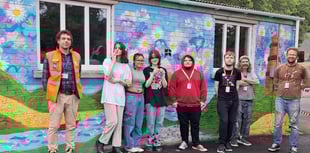 Students creating mural artwork at docks
