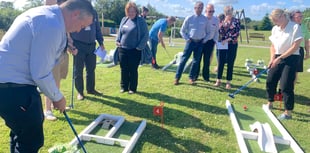 Business club members putt as well as pitch at networking event