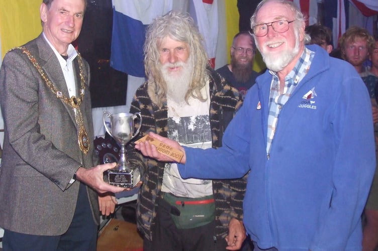 Mayor of Looe Stephen Remington presents the Western Bell, oldest skipper award, which was shared by Jono Brickhill and Tony Laurillard, both 79. (Picture: Peter Kinver)