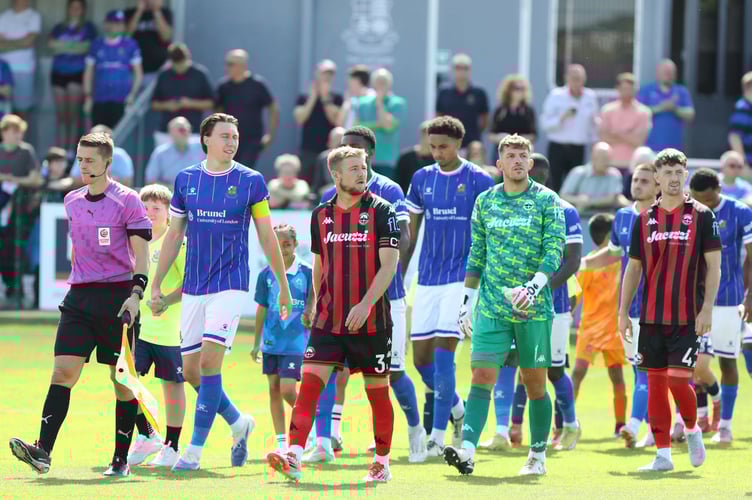 Connor Riley-Lowe leads out Truro for first National League match at Wealdstone on Saturday.