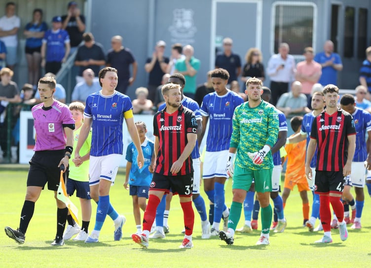 Connor Riley-Lowe leads out Truro for first National League match at Wealdstone on Saturday.