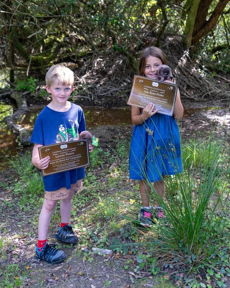 Lerryn (left) and Ada visit the Heligan beaver enclosure to receive certificates to celebrate their winning names.