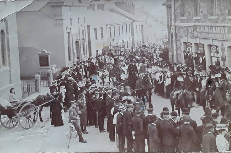 A parade passing Mr Blamey's Store in the early 1900s