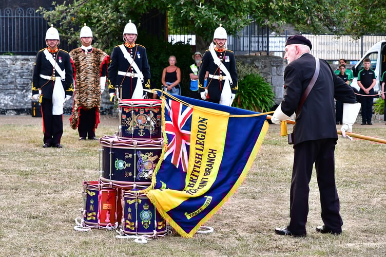A standard bearer from the Torpoint branch of the Royal British Legion pays his respects as part of the service
