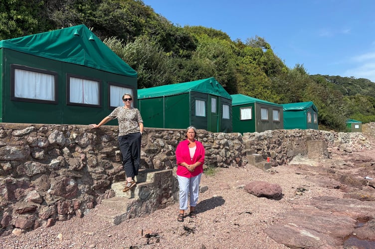 Cllr Kate Ewert, left, and Becky Lingard in front of the beach chalets which will now be removed as soon as possible by Cornwall and Plymouth councils 