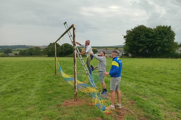 Volunteers get to work putting up the nets at St Neot AFC's pitch in Mount