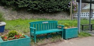 New bench and planters at bus stop outside railway station