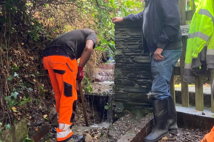 Cormac staff unblocking a drain for a stream running down to The Warren, Polperro, which had been filled with stones washed down in the storm