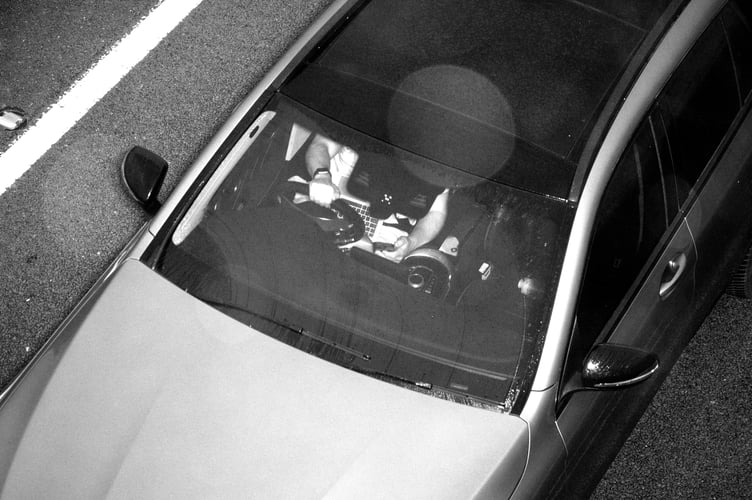 An image captured by the Acusensus camera system showing a driver using a laptop and mobile phone behind the wheel. (Picture: Devon and Cornwall Police)