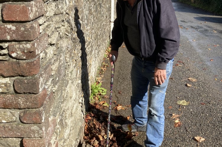 Cornwall councillor Jim Candy helping to clear leaves from drains during the recent inclement weather