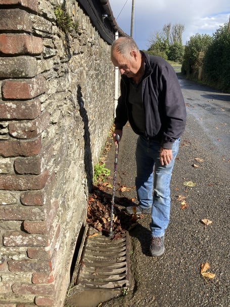 Cornwall councillor Jim Candy helping to clear leaves from drains during the recent inclement weather