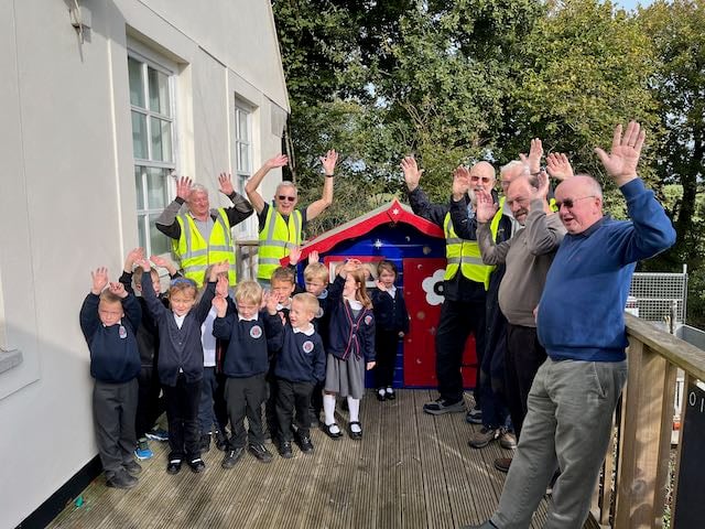 Youngsters from Trenode Church of England Primary Academy are all smiles after members of the Looe Shedders helped to renovate an old Wendy House