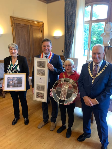 Civic leaders from both Quimperlé and Liskeard exchange gifts during the recent twinning visit