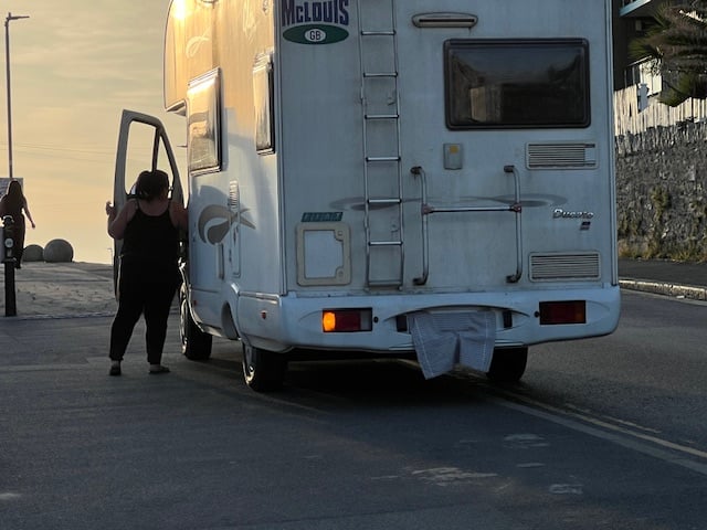 A motorist covering their registration plate along Headland Road before entering Towan Headland car park to avoid the ANPR camera