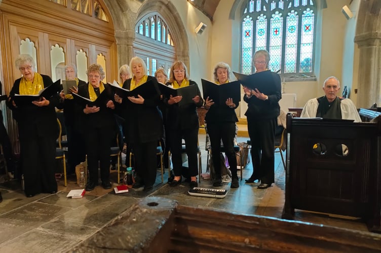 The 'Just Voices' choir and Lansallos parish Rector, the Reverend Richard Allen