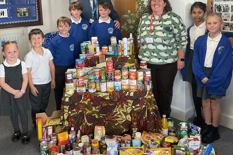 Brunel Primary and Nursery Academy headteacher Darren Woolner with pupils and staff following their successful Harvest Festival
