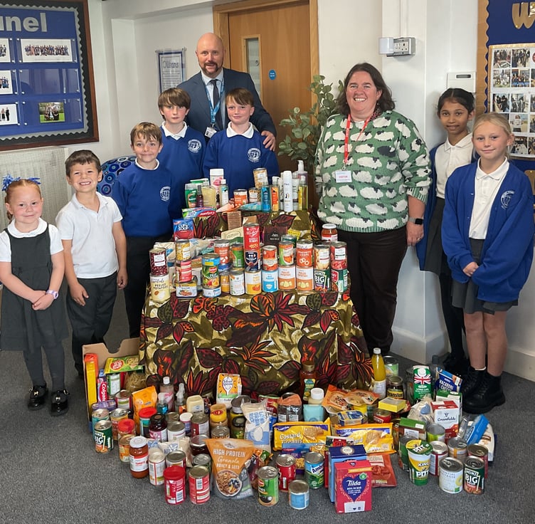 Brunel Primary and Nursery Academy headteacher Darren Woolner with pupils and staff following their successful Harvest Festival