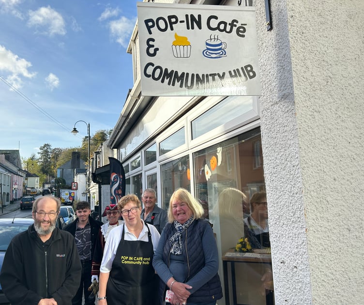 The launch of the new Pop-In Cafe and Community Hub in Calstock – a dream come true for founder Ruth Kelly-Williams, centre, and her fiance Andrew Cuer, back right. Also pictured, from left, signwriter Chris Clarke (left) and his wife, Gunnislake ward parish councillor, also Chris Clarke, right, who did the cafe flowers.  Cutting the ribbon was Cornwall councillor for Calstock Angus Black (back left, Reform UK), while Calstock town crier Hilary Fairhurst, back in her regalia, performed a special 'cry' in honour of the occasion.