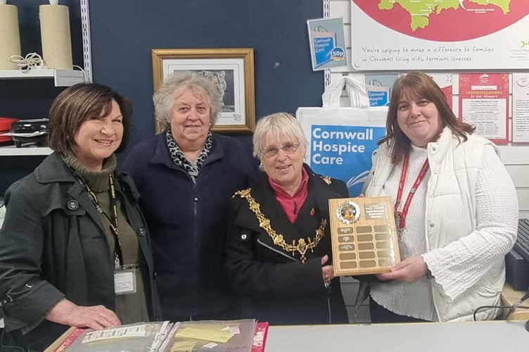 Bev Weller from Cornwall Hospice Care shop in Liskeard receives the plaque for Best Dressed Halloween Window from Lori Reid, Lin Moore and Mayor Christina Whitty