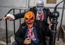 Zombies walk through streets in annual night of frights and fun