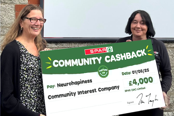Vicky Coxhead receives a giant cheque from Spar store manager Amanda Christian at Nanpean in the Clay Country.