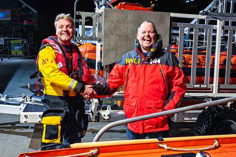 Goron Jones is congratulated on his qualification by Looe RNLI’s Lifeboat Operations Manager Clive Palfrey