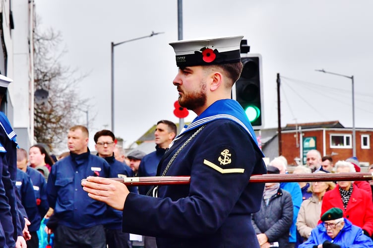 A serviceman stands at attention during the Remembrance Service in Torpoint