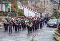 Remembrance parade in village contends with heavy rain and wind