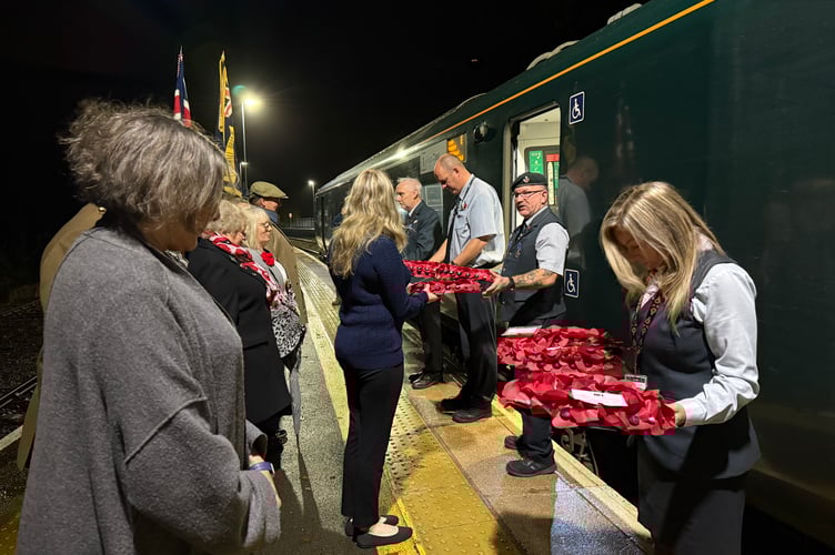 Margaret Schwarz presenting a Trust wreath to Great Western Railway Poppies to Paddington staff at Bodmin Parkway station