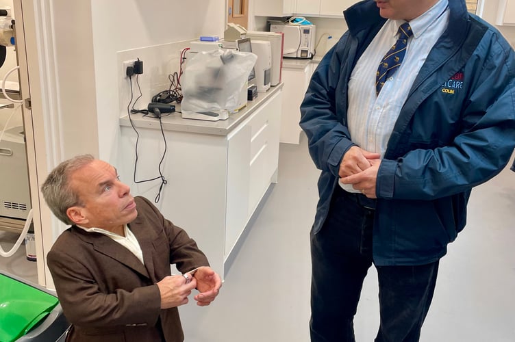Beacon VetCare owner Colin Whiting shows Warwick Davis around the new Par facility