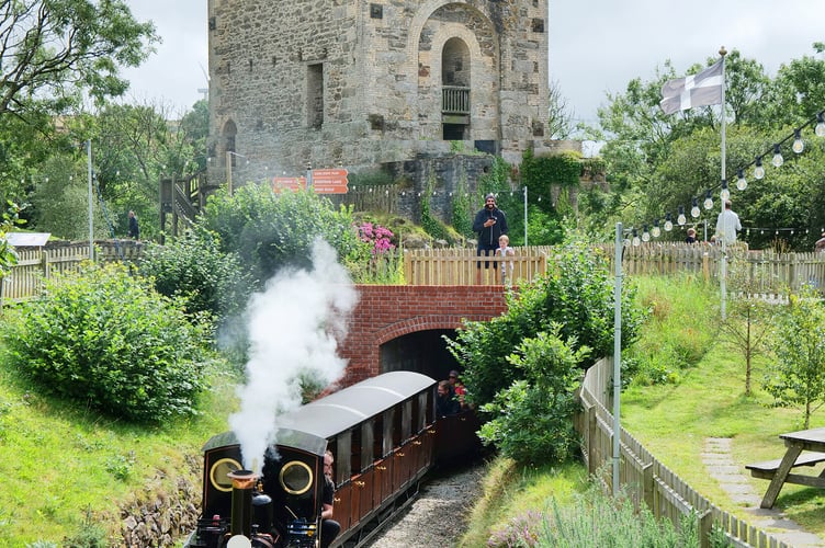 Lappa Valley steam locomotive Ellie pulls a train out from the historic surroundings of the former East Wheal Rose Mine