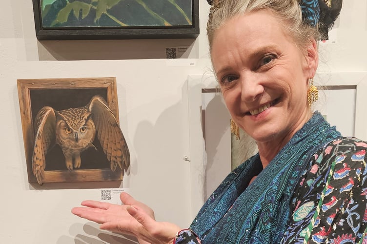 Lucinda Holland with the owl artwork at the exhibition. The piece has been bought by an actor.