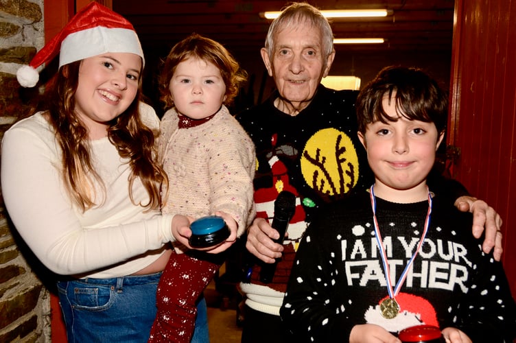 Two-year-old Daisy with sister Elsie and Noah holding the controls with which they switched on the Christmas Lights. They are pictured with Hall chairman Stephen Michael (Pictures: Sue Webb)