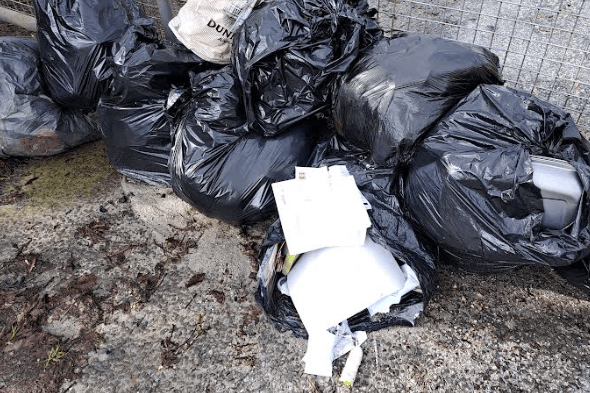 nine bags of rubbish dumped by gate 2.