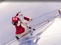 Santa shows how he gets to the ground without a chimney
