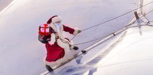 Santa shows how he gets to the ground without a chimney