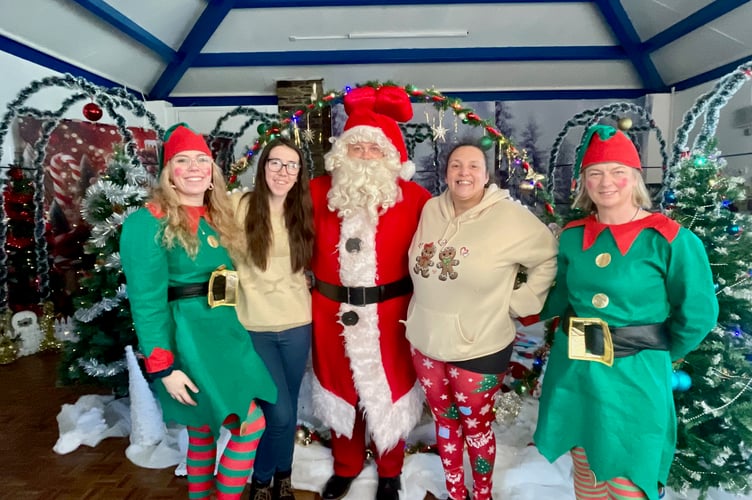 Members of the Beat4Autism team alongside Father Christmas and their special sensory Christmas Grotto