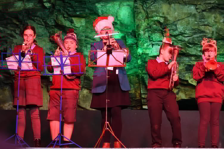 Laura-Beth from Liskeard Town Band with schoolchildren, performing Rudolph to delight the audience