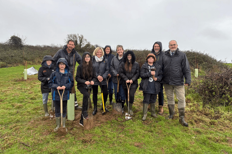 All smiles as the tree planting at Go beyond's Coastal Centre goes ahead despite the wet weather.