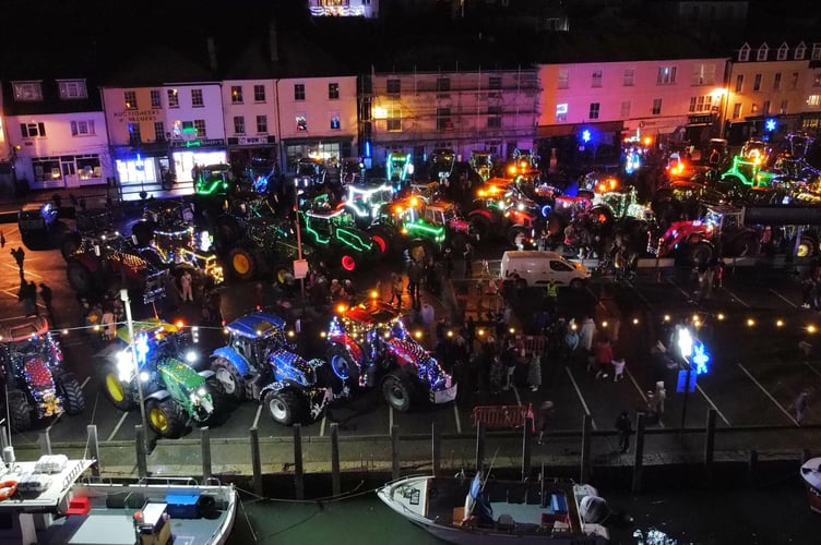 Looe harbourside all lit up with tractors which had taken part in the annual Tinsel Tractor Run