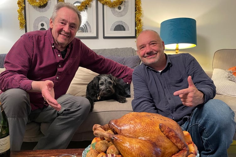 Gone Fishing presenters Paul Whitehouse and Bob Mortimore in front of the Christmas roast cake produced by Niki Lowe