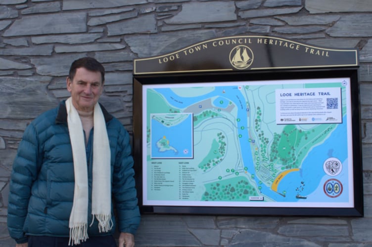 Looe town mayor, Cllr Stephen Remington in front of one of the five newly-designed heritage sign boards at key locations across the town