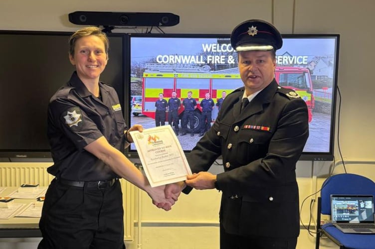 Group Manager Andy Sleeman (right) welcomes Saltash's newest firefighter Kim Barber on board