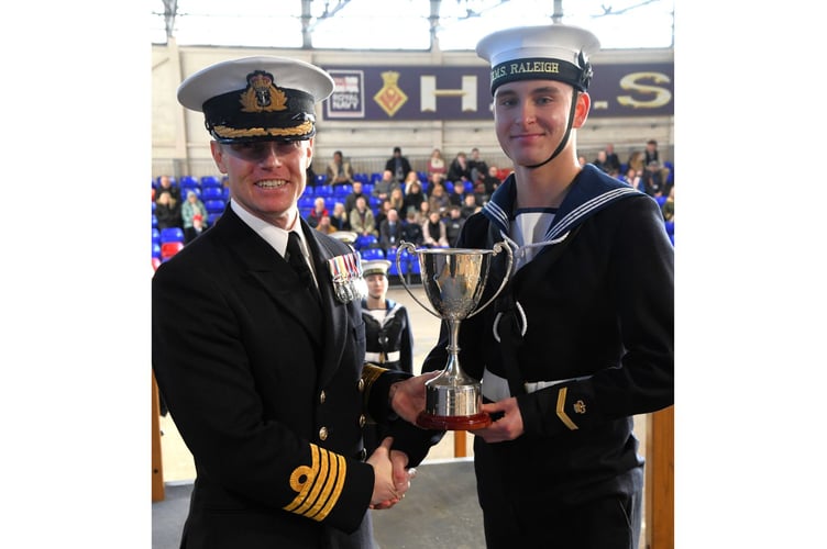 Commanding Officer of HMS Raleigh, Captain Jeremy Ussher presents the Captain’s Prize to Recruit Ethan Wain 