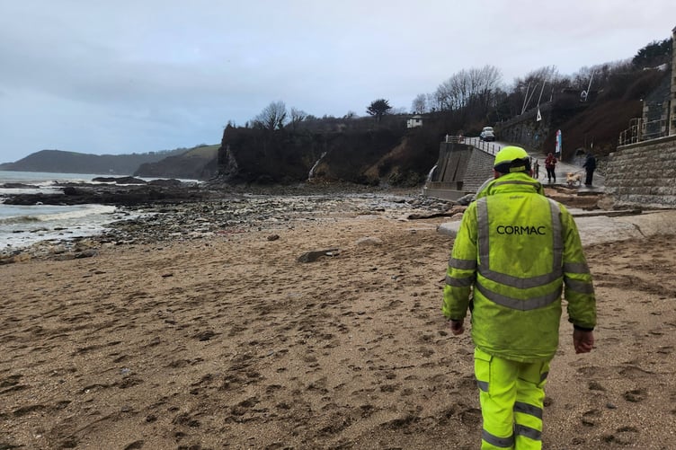 A Cormac worker at Porthpean beach after the damage was reported. (Picture: James Mustoe)