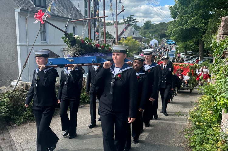 Central to the celebrations is the wooden Black Prince model boat, traditionally carried aloft through the villages by sailors from HMS Raleigh