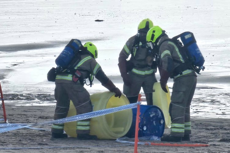 A fire crew wearing protective equipment lifted the drum into a chemical “over drum” on Par Beach. (Picture: St Austell Coastguard)