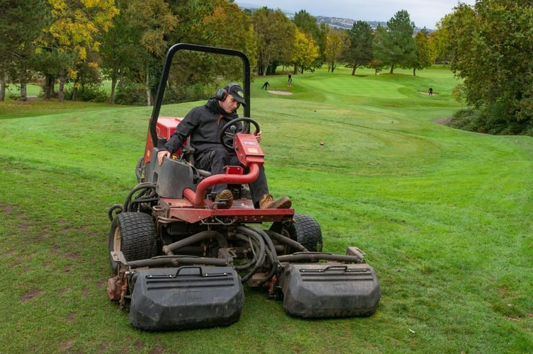 Oban Webber hard at work helping to maintain the golf course at China Fleet Country Club