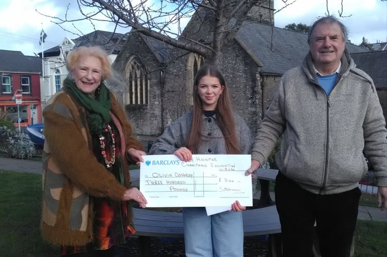 Trustees Sue Hooper and Ken Martin hand over a cheque for £300 to young performer Olivia Cleverley 