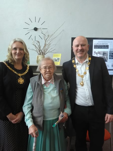 Audrey Miller (centre) alongside Saltash Town mayor Cllr Rachel Bullock and her husband Matt at the opening of the exhibition at the Saltash Library Hub